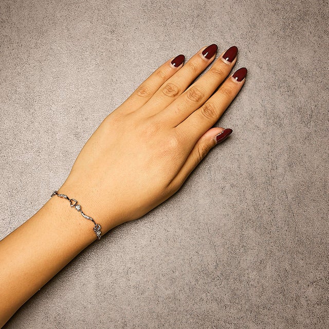 Envelop your wrist in a symphony of elegance with this exquisite bracelet, where classic romance meets modern design....