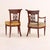 The set comprises five side chairs and one commanding armchair, each meticulously crafted from finely figured solid walnut...