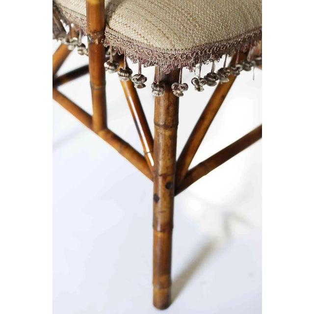 Antique asymmetrical Aesthetic Movement chair. Faux tortoise bamboo with upholstered seat, back and arms Tassels on the...