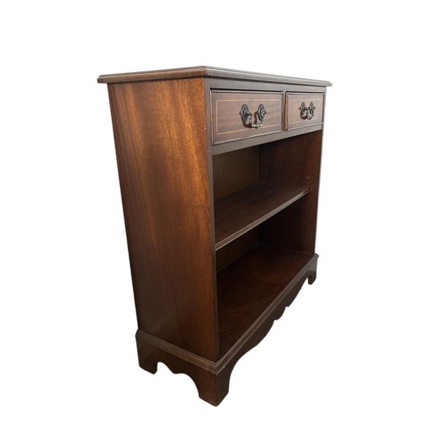English-style sideboard in mahogany wood with two drawers and an open shelf. Features classic brass handles and a clean,...