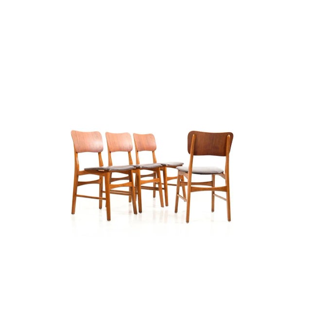 This set of four mid-century Danish dining chairs features backrests in teak and frames in solid beech. The chairs are...