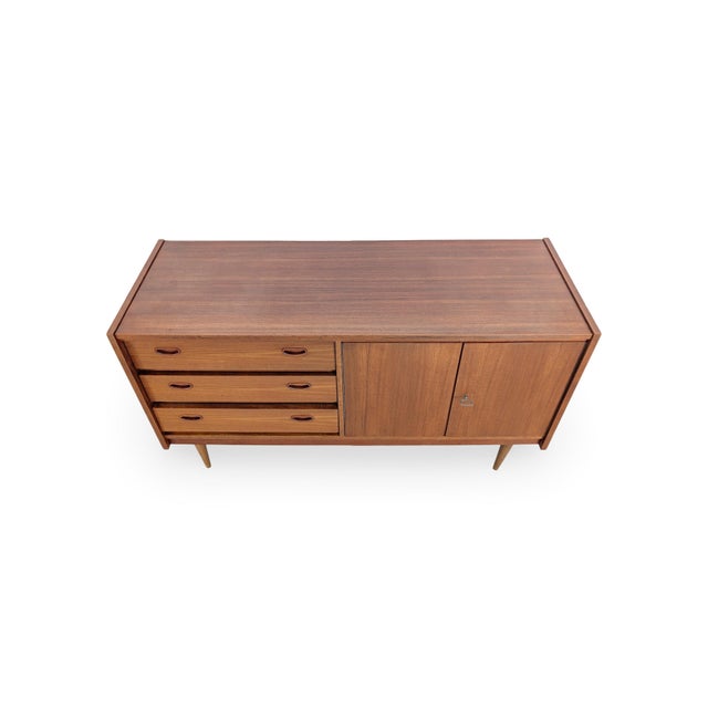 We are offering a beautiful teak mid-century sideboard from the 1960s for sale. Despite its compact size, this sideboard...