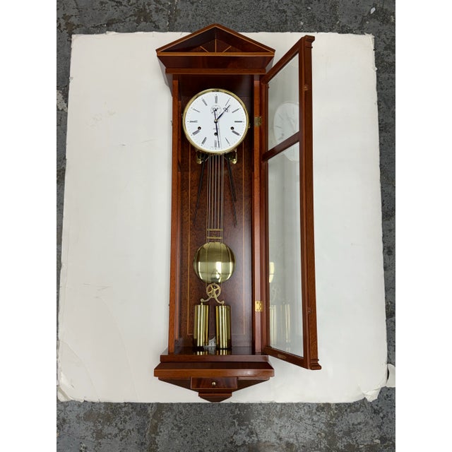 Design Plus Gallery presents a Mahogany Regulator Wall Clock from Kieninger. Classic Wiener Dachl-type miniature regulator...