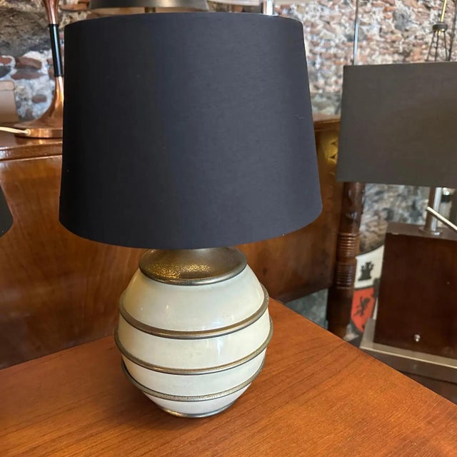 This 1970s Mid-Century Modern set of Italian table lamps, in the manner of Tommaso Barbi, exudes sophisticated elegance...