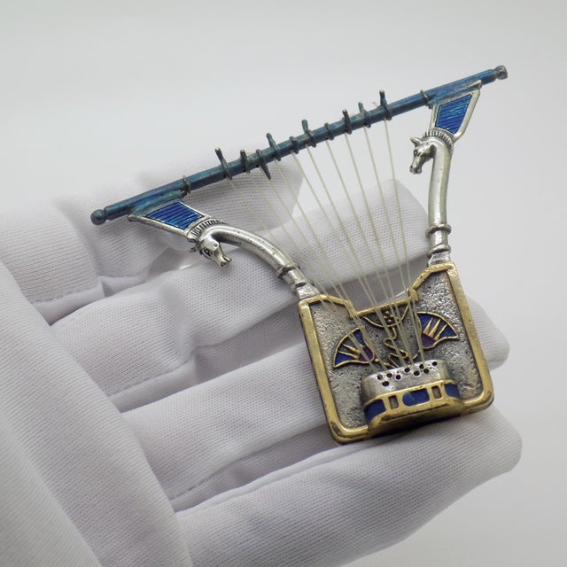 A vintage sculpture depicting an egyptian lyre, handcrafted in florence between the 1980s and 1990s in solid continental...