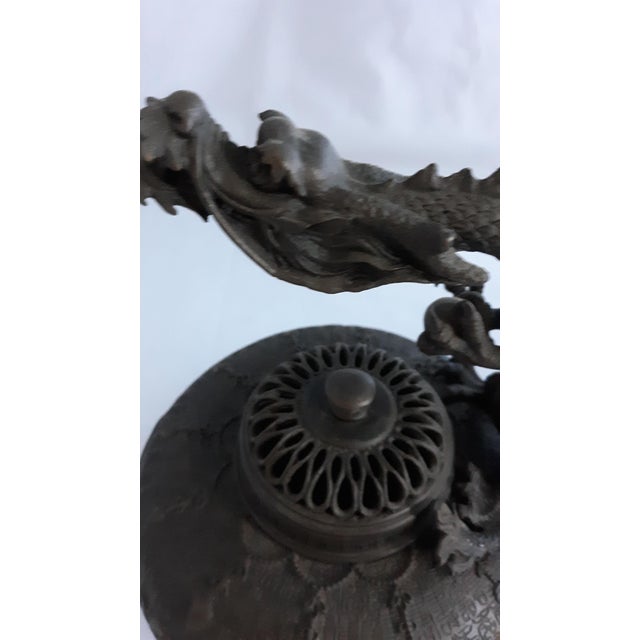 This is a magnificent vintage Chinese bronze/brass tripod censer (incense burner) featuring a dramatic, high-relief...