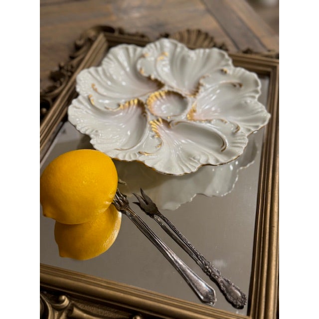 A rare matched pair of early 20th-century Antique French Limoges oyster plates, each featuring six sculptural scalloped...