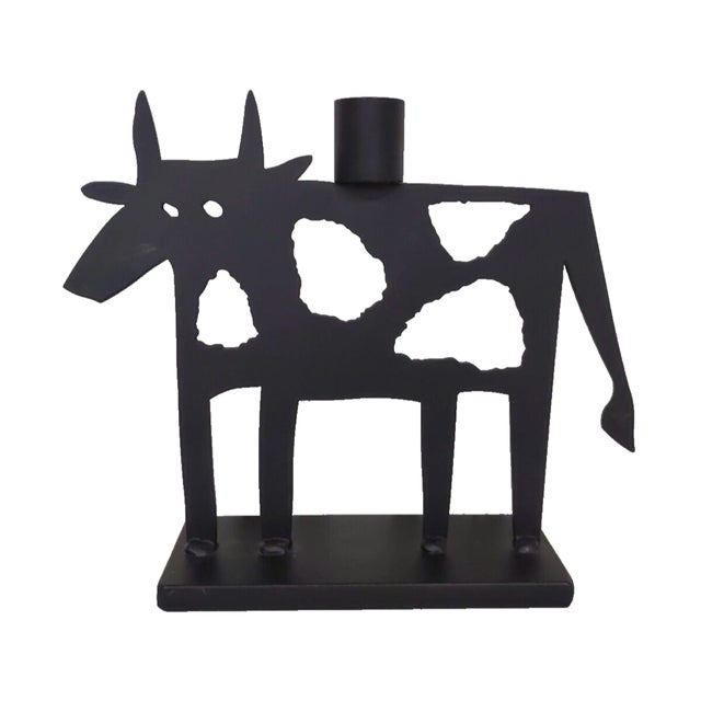 This is a pair of vintage metal sculptures that feature abstract cows with spots, perfect for adding a touch of whimsy to...