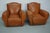 These club chairs were designed and produced in France during the 1940s. The chairs are made from cognac leather held...