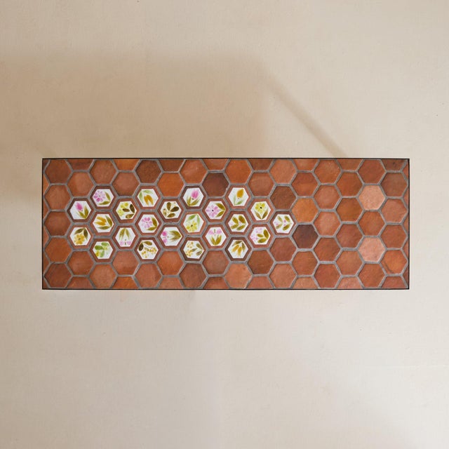 A French ceramic tile coffee table by Roger Capron, crafted in Vallauris in the 1950s. A field of hexagonal terracotta...
