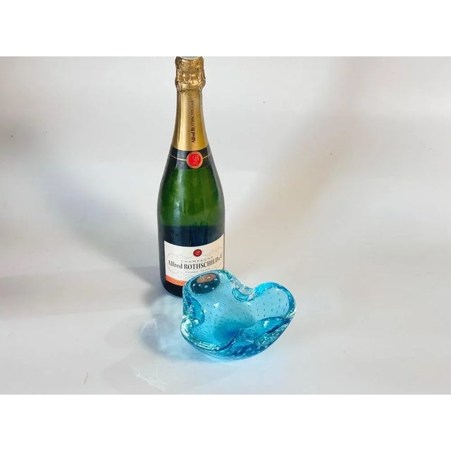 This vide poche or ashtray in in Glass. It has been done circa 1970, in Murano, Italy\. The shape is a free form....