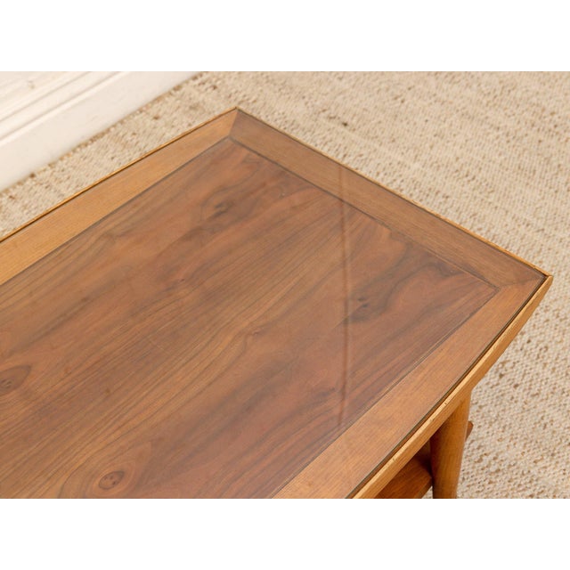 A handsome vintage Lane Furniture “Copenhagen” coffee table with a warm sculptural wood frame, inset glass top, and...