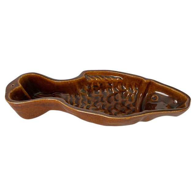 This Ceramic Ashtray or Vide Poche, has a Fish Shape. The colors are the Brown. It has been made in Italy Circa 1960.