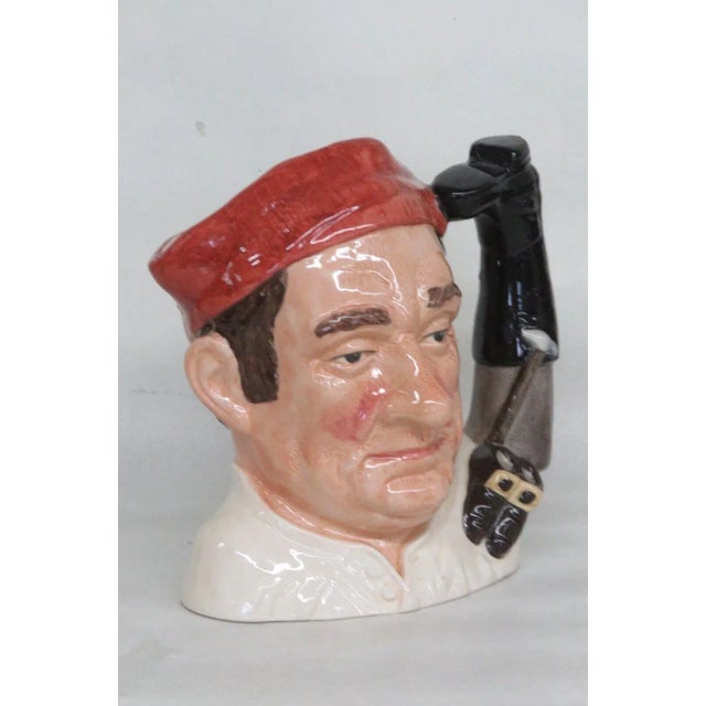 This interesting mug is made of porcelain. This character mug is stamped as being made in England by Royal Doulton in 1962...