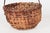 Antique hand-woven American splint basket in the classic gathering form, featuring a steamed and bent hardwood handle...