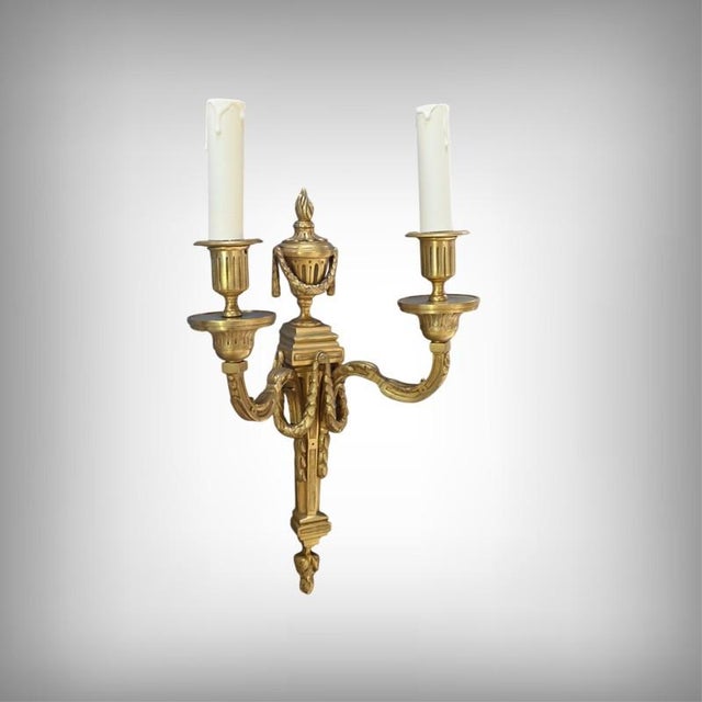 Crafted from finely chiseled bronze, these elegant two-light wall sconces perfectly illustrate the neoclassical taste of...