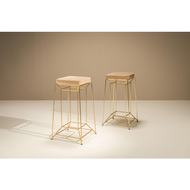 A light architectural frame and warm upholstery give this pair of Italian bar stools an understated presence. Attributed...