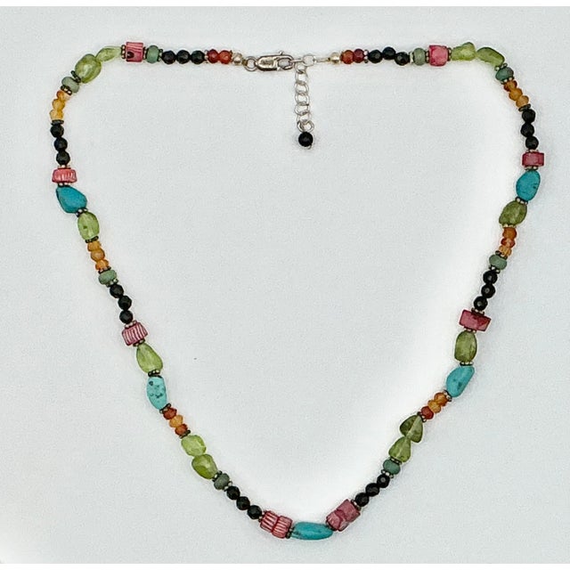 This is such a lovely little Beaded Necklace. It has a colorful mix of beads and five petite Turquoise rocks. They are...