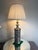 pair of MCM pierced metal lamps inspired by Moroccan spice jars, featuring a cylindrical pierced metal base with a...