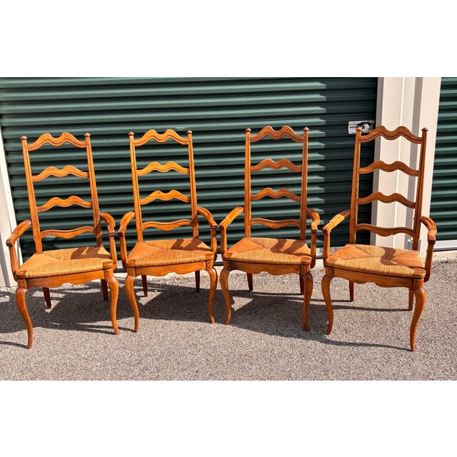 Wonderful vintage set of hardwood French Country ladder back armchairs with rush seats. These are circa 1960 and are in...