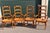 Wonderful vintage set of hardwood French Country ladder back armchairs with rush seats. These are circa 1960 and are in...