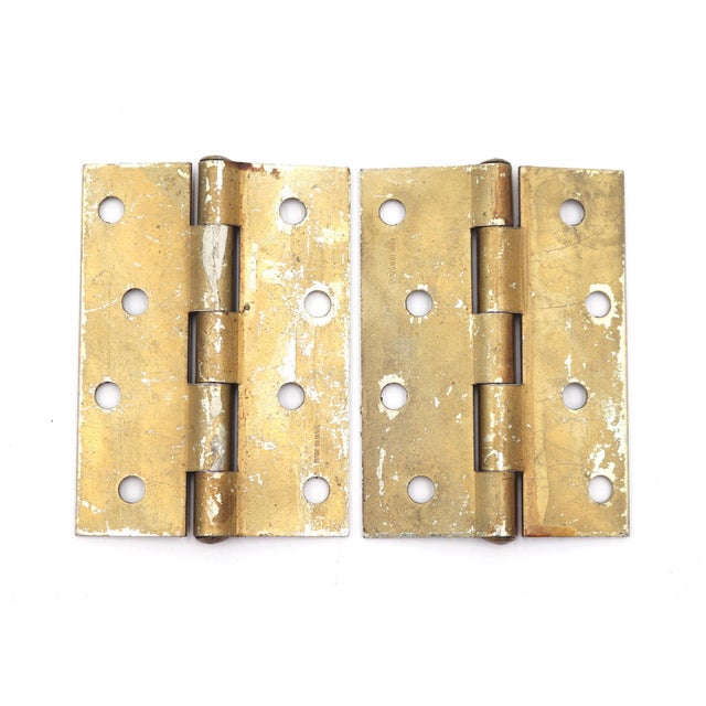 These cabinet door hinges are made of brass plated steel with flat tips, five knuckles, and a staggered hole pattern. The...