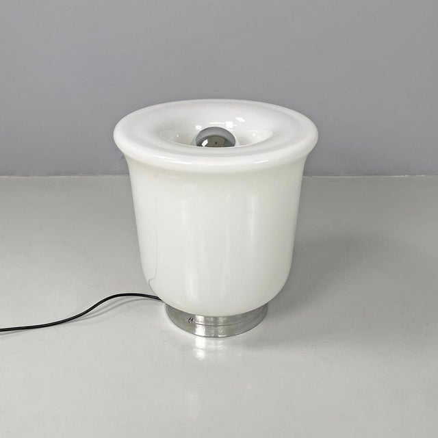Italian modern round table lamp with curved profiles metal and white glass 1970s Table lamp with round base. The round...