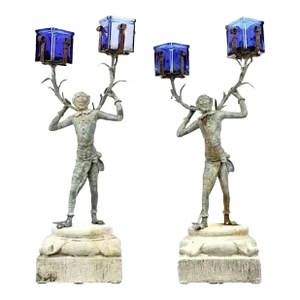 A Pair of Bronze Monkey Butler Candlesticks