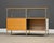 A mid century modern designed maple top sideboard credenza designed by Charles and Ray Eames for Herman Miller with a...