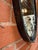 Striking vintage wall mirror featuring an elongated oval form set within a hand-forged iron frame. The dark patinated...