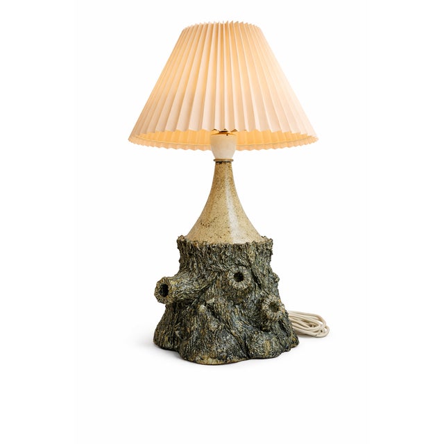 This piece reflects the Scandinavian studio ceramics tradition, where natural textures and earthy glazes are combined with...