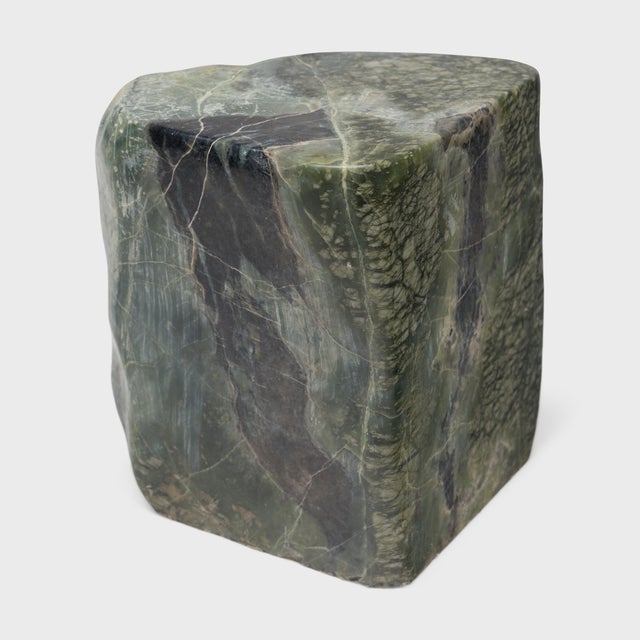 This low stone table is shaped from a captivating material known as greenery stone, named for its naturally occurring...