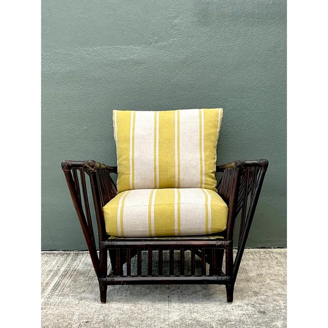 This vintage stick rattan lounge chair showcases the classic geometric styling synonymous with early 20th-century tropical...