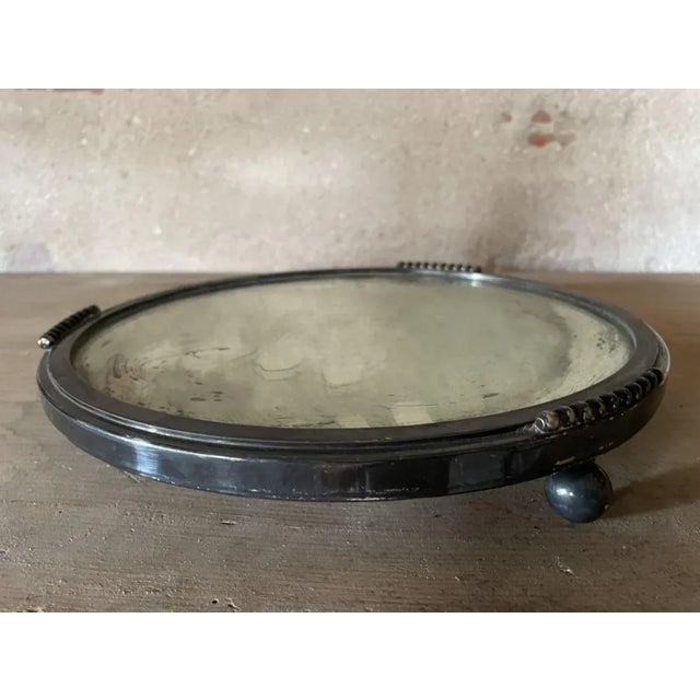 Silver-plated metal tray with antique mirror.