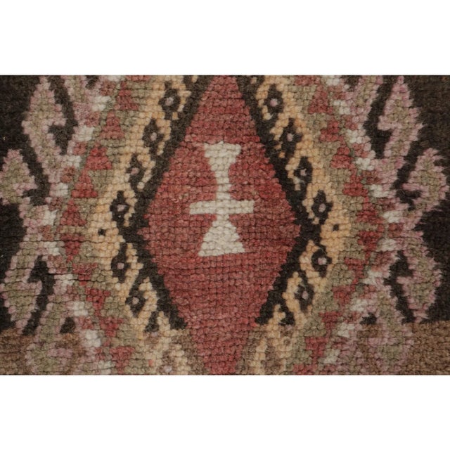 This vintage 2x3 Turkish gift-size rug, circa 1950–1959, features a pair of geometric medallions rendered in rose, ivory,...