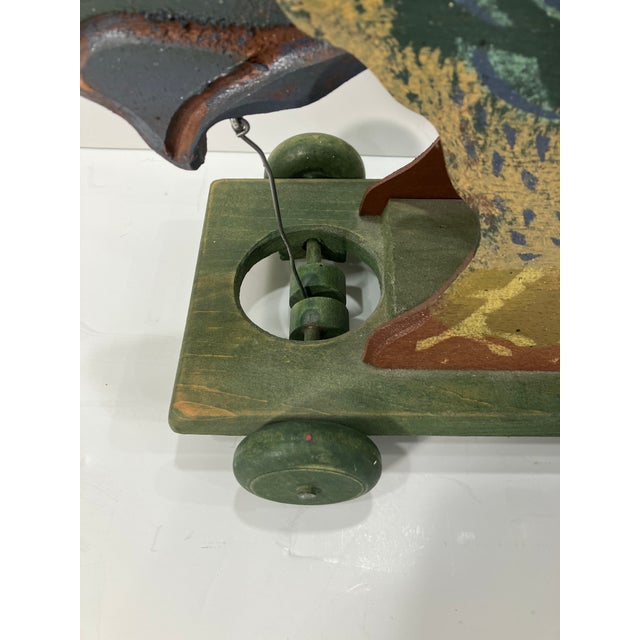 This hand crafted pull toy is signed Paul Stiffle dated 1993 All original The head and tail move when the back wheels spin...