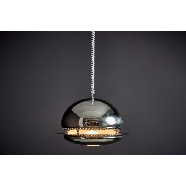 The Nictea pendant is composed of two rounded sections, seamlessly connected by carefully integrated metal components that...