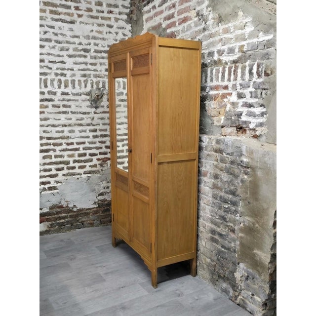 Art Deco wardrobe circa 1930. Features a mirrored front. Three shelves, providing four storage compartments. There is a...
