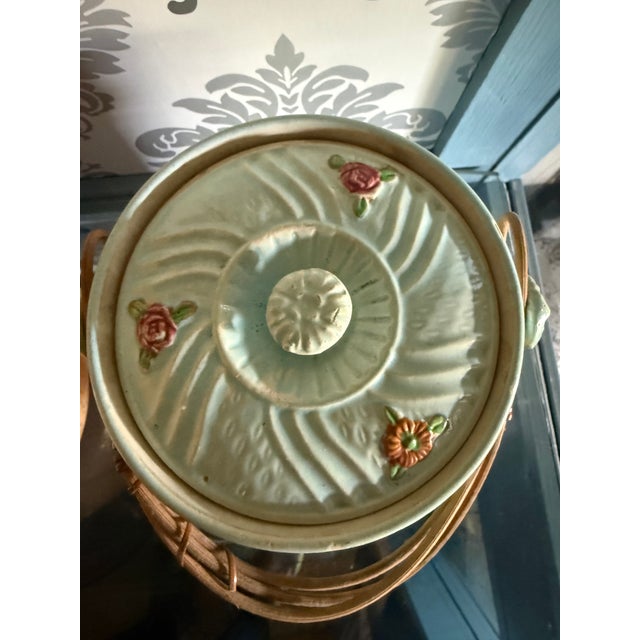 This item is a vintage 1940's Japanese Majolica biscuit jar. Wicker handle is a bit loose at loop so be careful lifting....