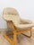 This elegant vintage Danish made tan leather cantilever armchair is a refined and collectible mid-century modern seating...