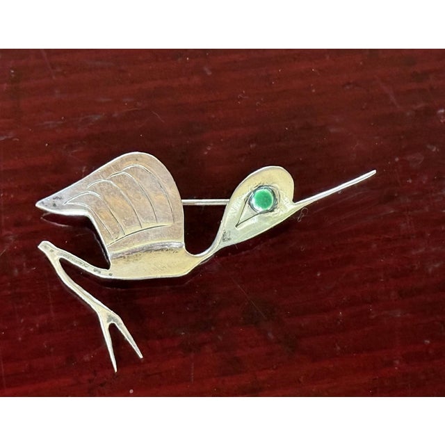 A sculptural sterling silver brooch with green cabochon inlay by Graziella Laffi (1923-2009), Lima, Peru, circa 1960-70s....