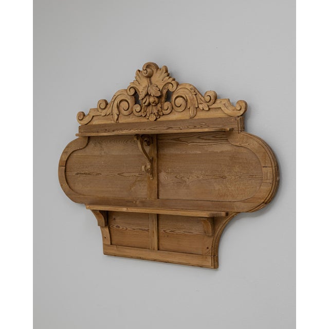 This 19th-century French carved wooden wall shelf showcases an elegant sculptural form rooted in classical decorative...