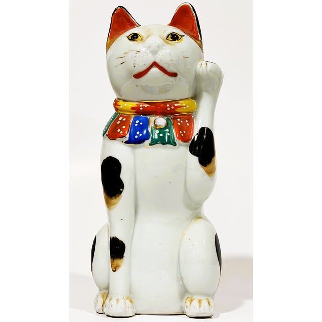 This small statue is called a Maneki-neko in Japan or a lucky or beckoning cat as it beckons inside those who pass by. It...