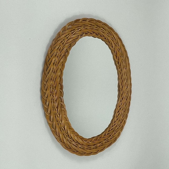 This mid-century French Riviera style wall mirror was designed and manufactured in France in the 1960s. The rattan frame...