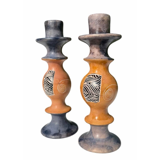A striking pair of vintage carved soapstone candlesticks featuring sculptural postmodern forms with hand-painted abstract...