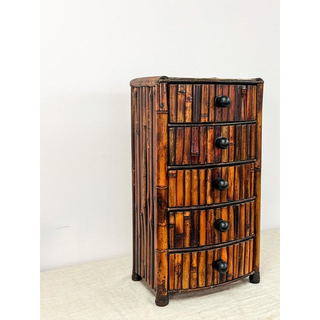 Add warmth and texture to your space with this vintage burnt bamboo 3-drawer storage chest. Featuring a rich, caramelized...