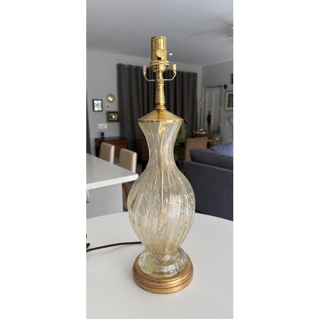Murano Italian hand blown gold inclusions ribbed glass table lamp with. The blown glass has controlled bubbles throughout,...