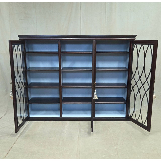 A beautiful and functional vintage English three section bookcase with 12 adjustable shelves. Notable are the doors with...