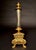 A refined 19th-century Grand Tour thermometer, executed in gilt bronze with a silvered bronze central cylinder, reflecting...