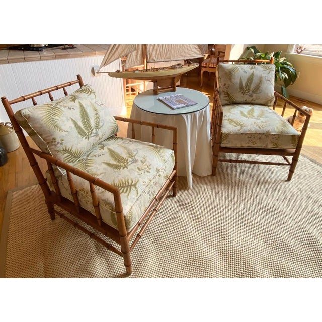 A Pair of Faux Bamboo Chinese Chippendale Chinoiserie Lounge Chairs A pair of iconic 20th Century Lounge Chairs — classic,...